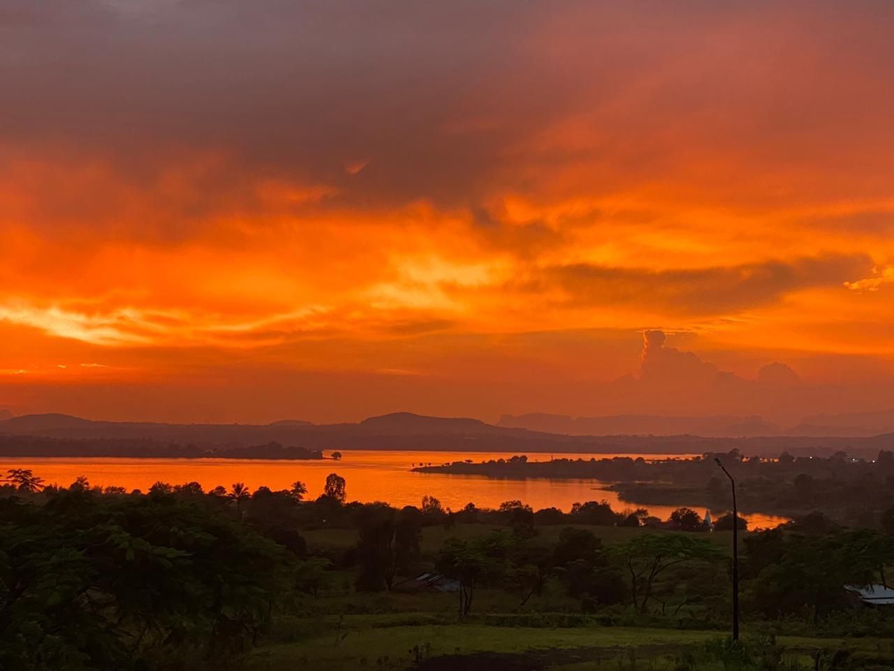 A fiery orange sunset over the lake